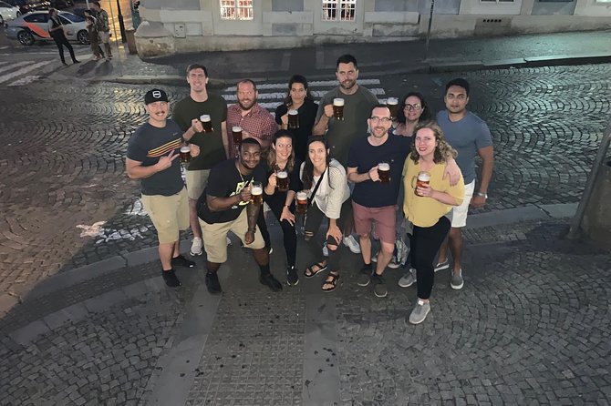 Old Prague pubs tour. Beer and dinner included! - Crossing Charles Bridge after dark