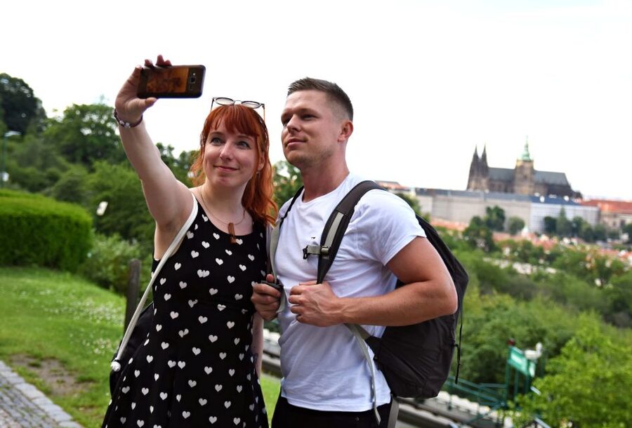 Panoramic Views of Prague Evening Walking Tour - Crossing Charles Bridge toward the illuminated castle