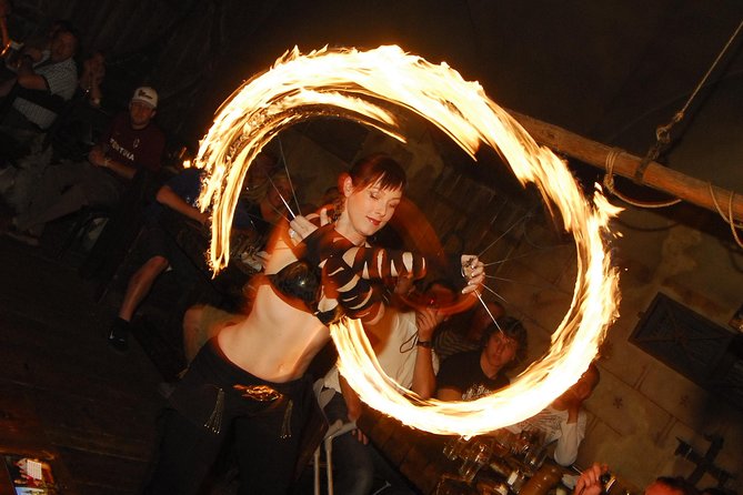 Prague 5 Courses Medieval Dinner and Live Performances - A candlelit tavern with shared wooden tables